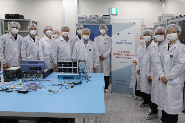 2025년 8월 12일 우주항공청과 참여기관 개발자들이 미국 NASA 케네디우주센터로 이송되는 큐브위성 'K-라드큐브' 비행모델 앞에서 기념촬영을 하고 있다. 한국천문연구원 제공