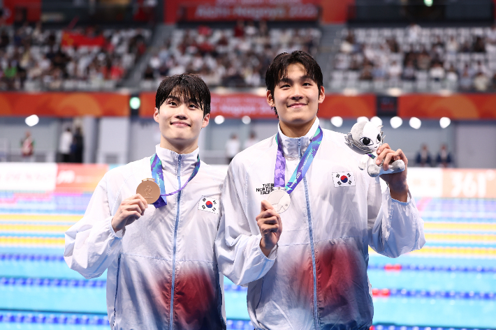 20일 도쿄 아쿠아틱스 센터에서 열린 2026 아이치·나고야 아시안게임 수영 남자 100m 자유형 결승에서 은메달과 동메달을 획득한 한국 김영범(사진 오른쪽), 황선우가 기념촬영하고 있다. 연합뉴스