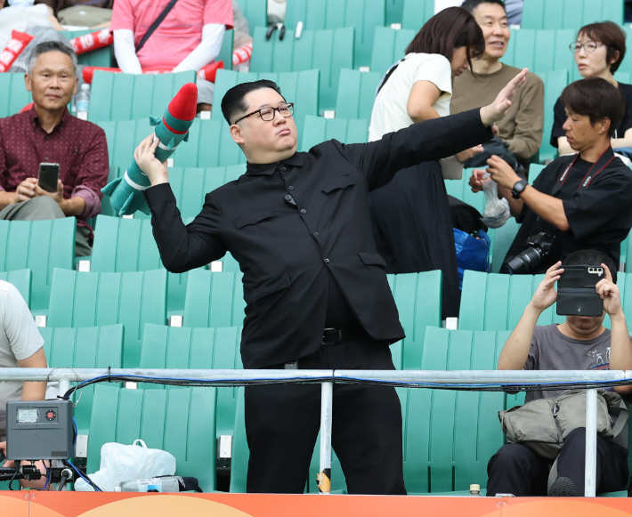 21일 일본 시즈오카현 후쿠로이의 시즈오카 스타디움 에코파에서 열린 2026 아이치·나고야 아시안게임 여자 축구 조별리그 대한민국과 북한의 경기. 관중석에 북한 김정은 국무위원장을 흉내낸 듯한 관람객이 눈길을 끌고 있다. 연합뉴스
