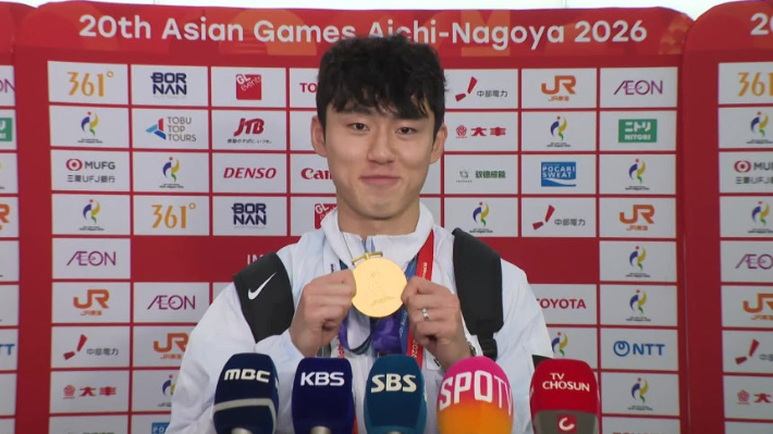 2026 아이치-나고야 아시안게임 남자 축구 금메달을 따낸 뒤 대표팀 주장 이기혁이 방송사 인터뷰에서 금메달을 들어 보인 모습. KBS 중계 화면 캡처  