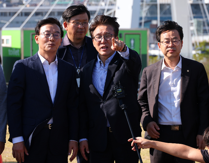  더불어민주당 김민석 대표가 17일 부산 동구 북항 재개발지역 내 복합형 돔 아레나 건립 예정지를 찾아 전재수 부산시장으로부터 사업 설명을 듣고 있다. 왼쪽부터 전재수 부산시장, 김민석 당대표, 박홍배 부산시당위원장.연합뉴스