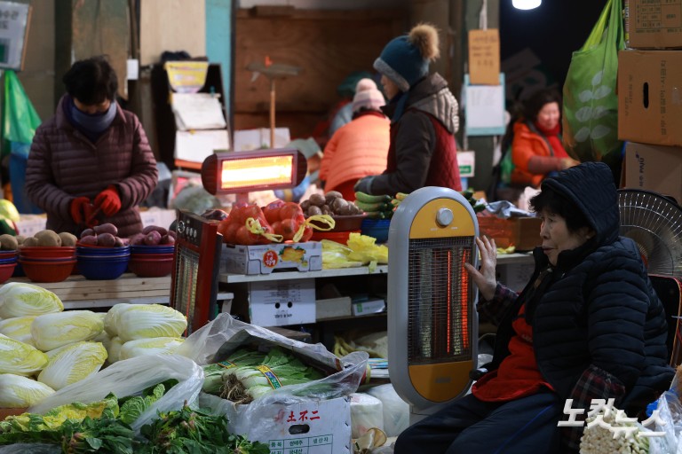 난로 쬐며 추위 녹이는 시장 상인들